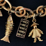Fish, abacus and a Chinese man - gold charm bracelet
