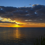 Sun Bursting Through Clouds Splitting Sky Over Tampa Bay Into Reds & Blues - IMRAN&trade;