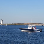 Lizaloo, boat crossing the harbor, view to lighthouse, Edgartown, Massachusetts