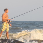 Fisherman fishing off the rocks in the Atlantic Ocean