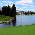 The 16th hole green with Lac Beauvert and the Jasper Park Lodge in the background / Jasper Park Golf Course