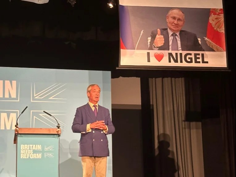 Protesters disrupt Nigel Farage speech by unfurling massive Putin banner, led by Donkeys