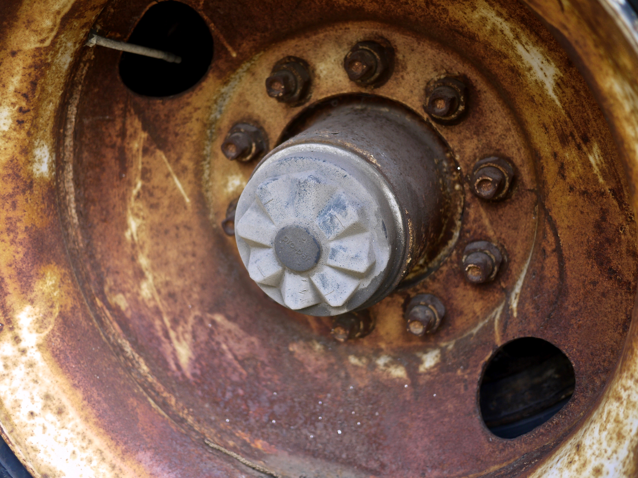Close up of a rusted tire wheel well.