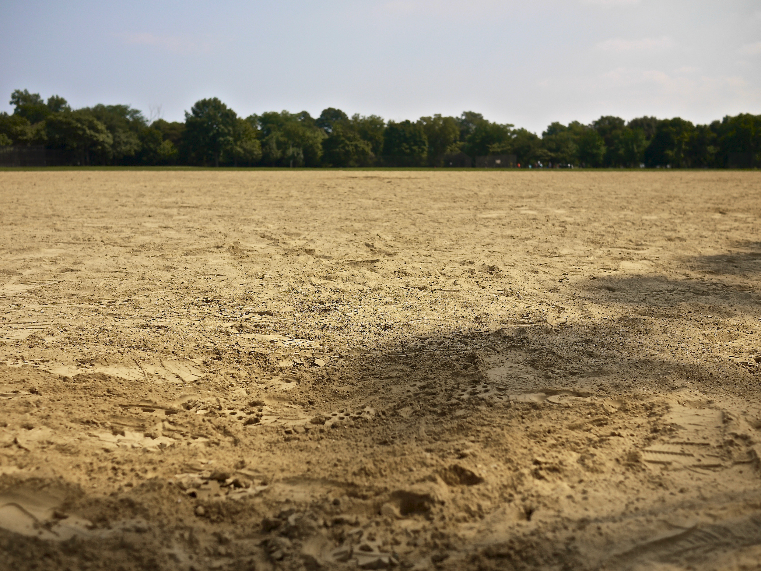 A close up of the dirt of a baseball field.