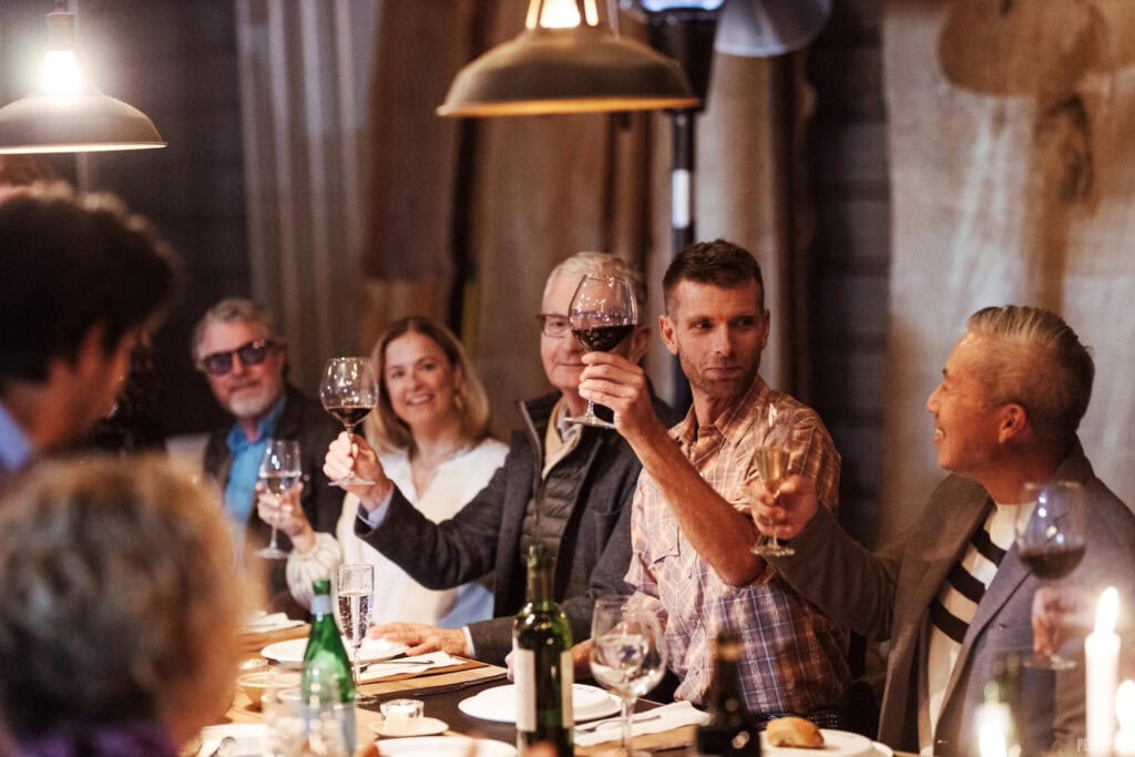 Friends raise glasses in a toast at an intimate gathering