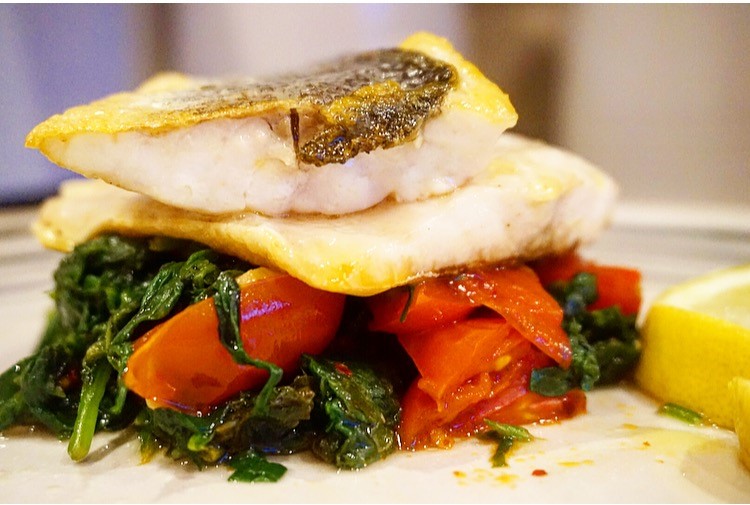 Pan fried sea bass with spinach tomato base The Tiny Italian