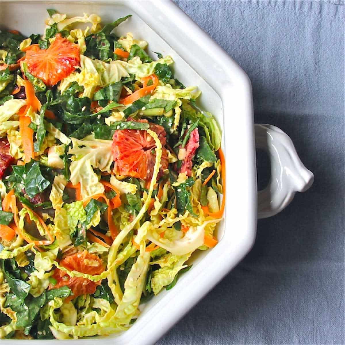 Winter Salad with Kale and Cabbage centered - 600 Large bowl filled with a salad of kale, cabbage and slices of blood oranges.