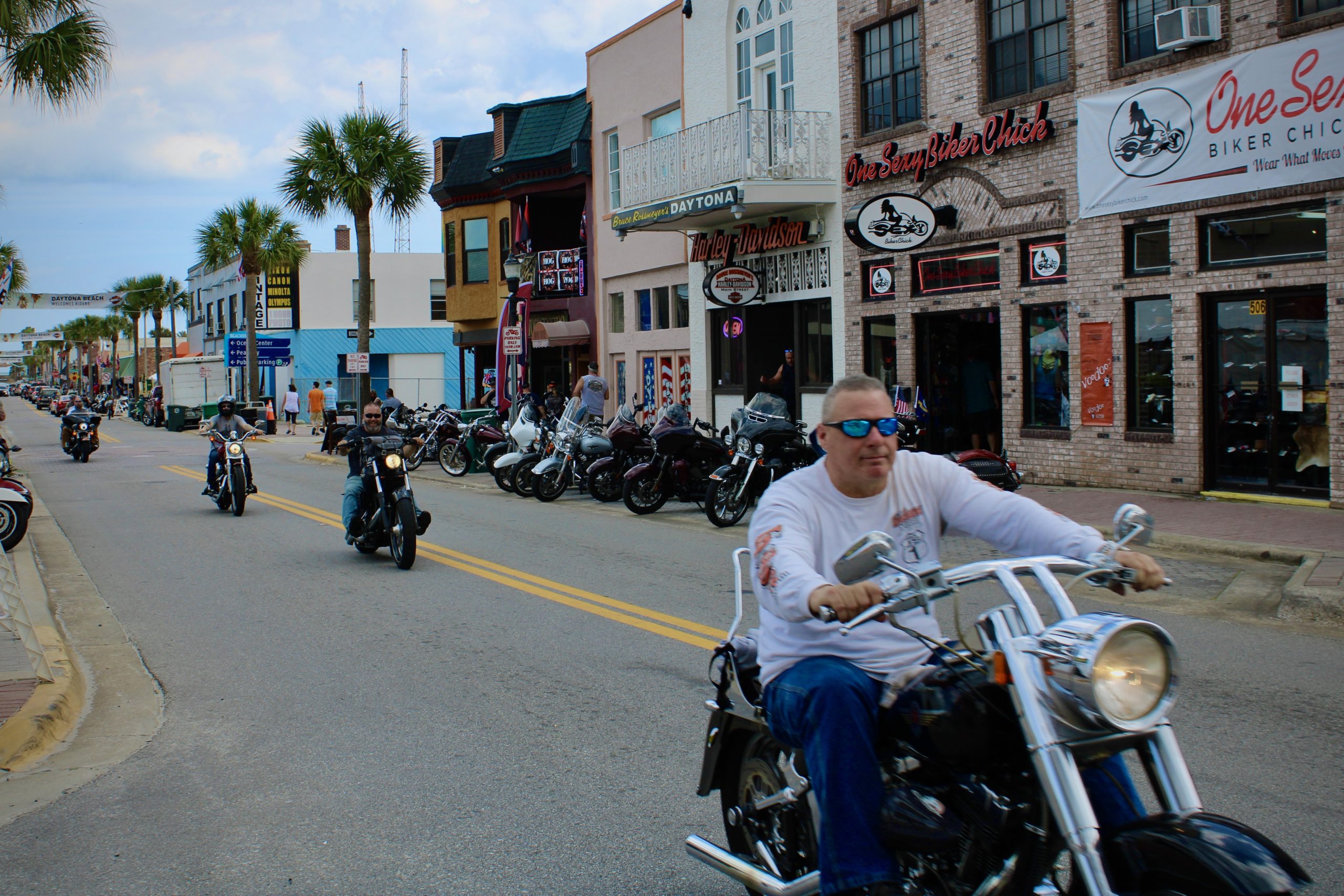 Bikers on v-twin motorcycles cruise Main Street at Daytona Beach Bike Week 2020.