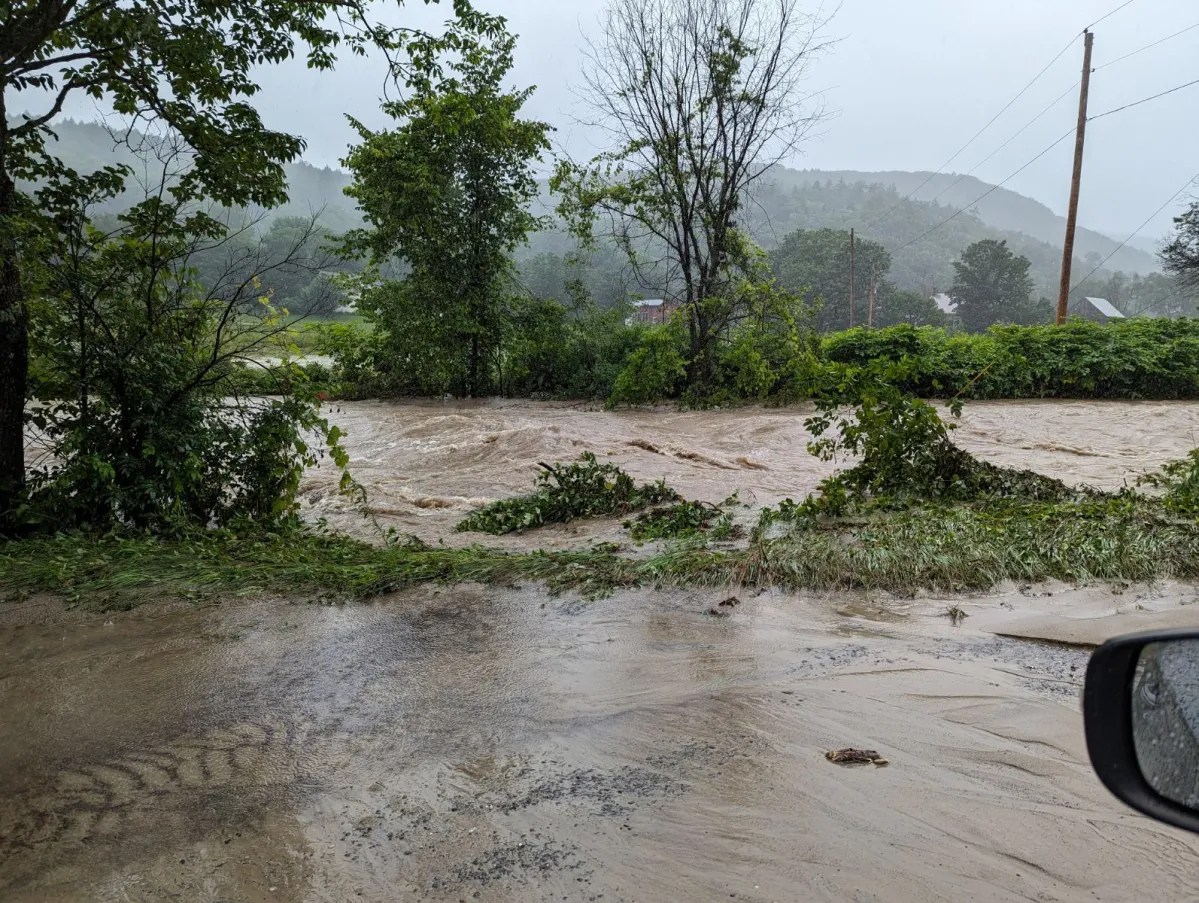 a car is driving down a flooded road.