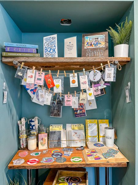 nook filled with cards, buttons, and stickers for sale at Chapter One Coffee