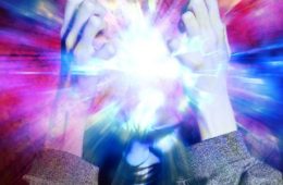 A human holding their head with different coloured lights shining out