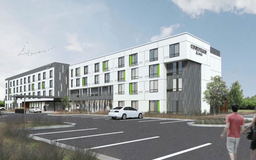 Exterior rendering of a modern Courtyard by Marriott hotel, featuring sleek design, green accents, and landscaped surroundings.