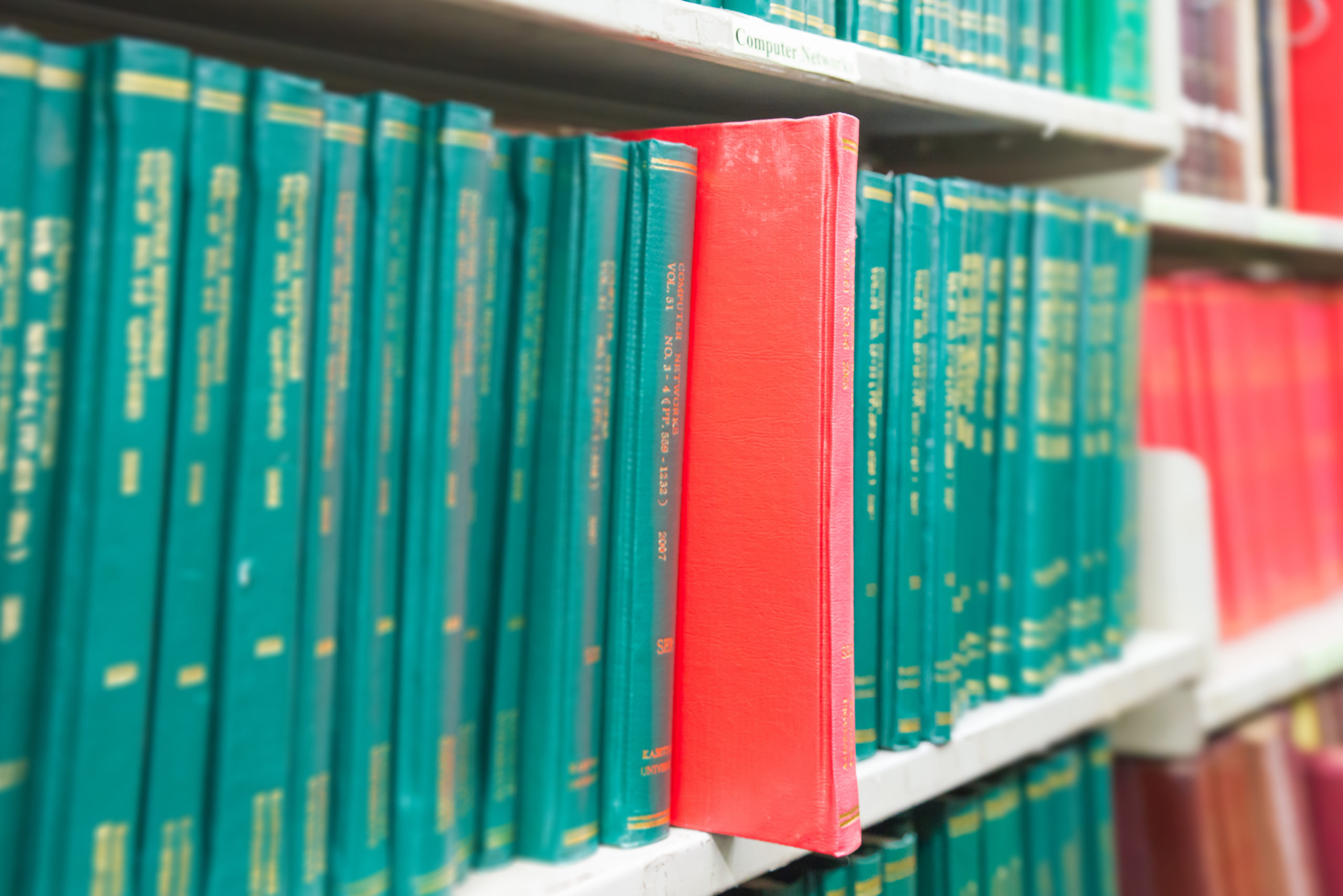 Book in a bookshelf standing out at university library