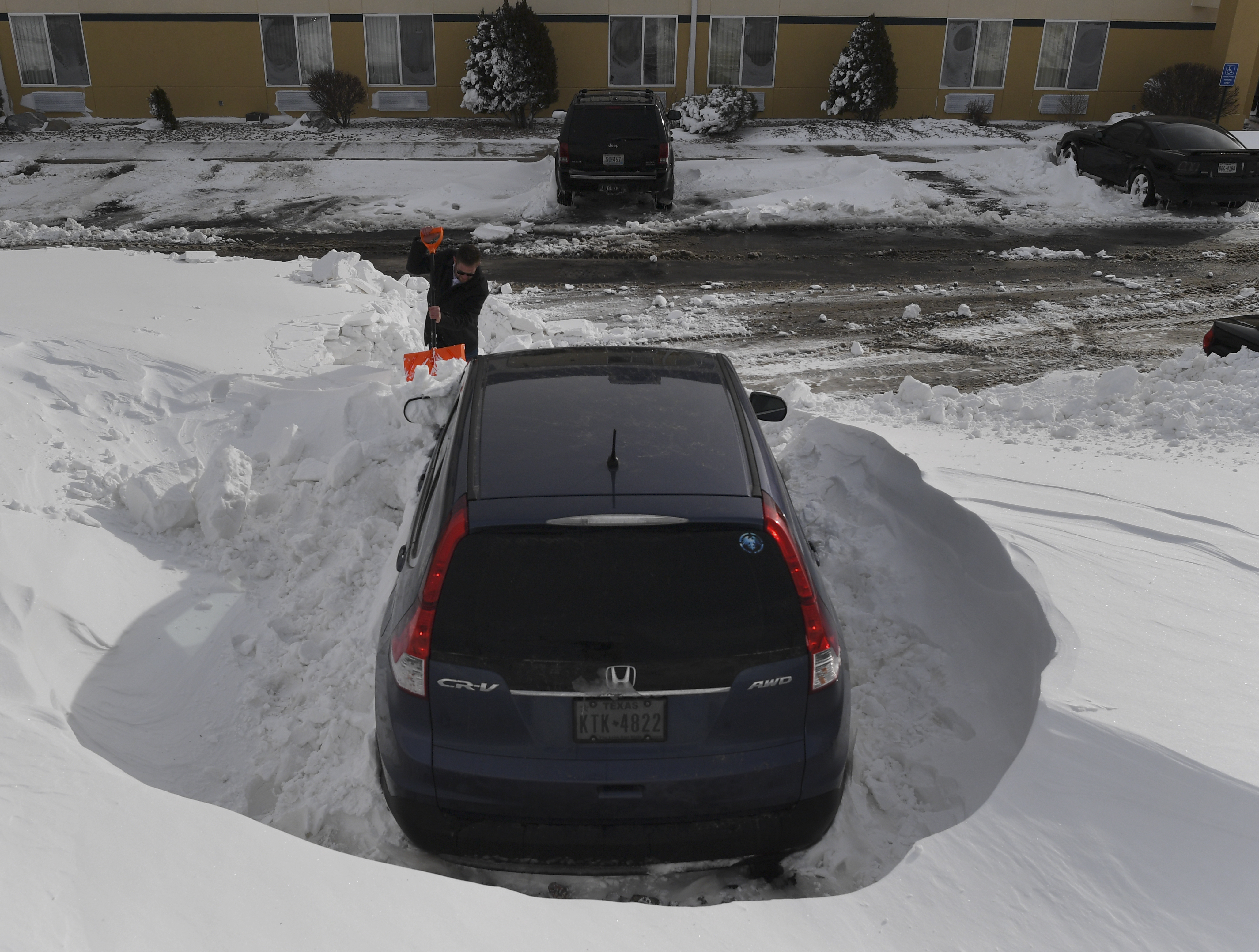 Matt Hermanson finishes up digging out, ...