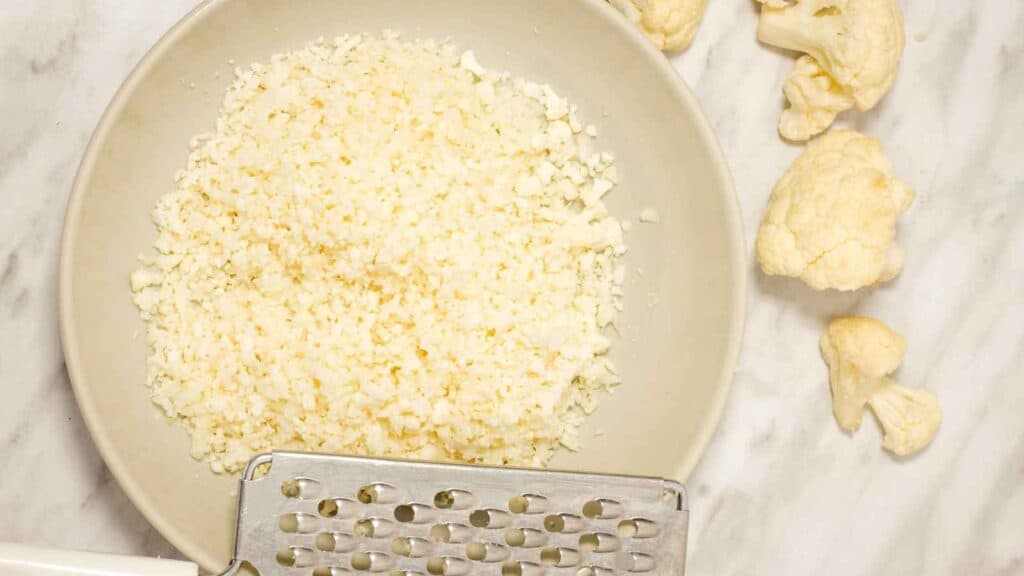 Use a cheese grater or food processor to make the cauliflower rice.