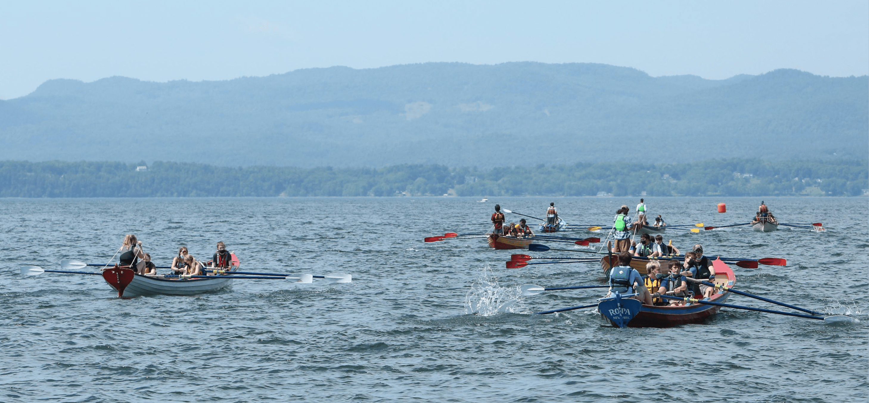 Seven pilot gigs rowed by high school students race across Lake Champlain