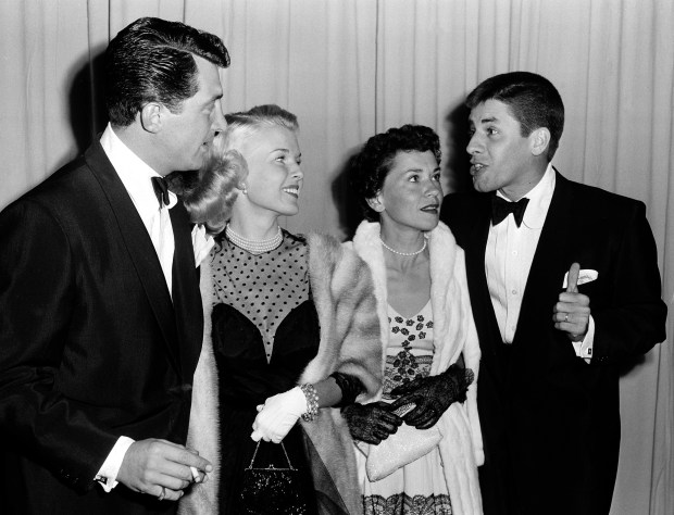 FILE - In a March 29, 1951 file photo, actor-comedian Dean Martin, left, and his wife, Jeanne, are shown with actor-comedian Jerry Lewis, far right, and his wife, singer Patti, as they arrive at the Academy Awards presentations at the RKO Pantages Theatre in Los Angeles. Jerry Lewis, the comedian and director whose fundraising telethons became as famous as his hit movies, died Sunday, Aug. 20, 2017, in Las Vegas, according to his publicist. He was 91. (AP Photo, File)