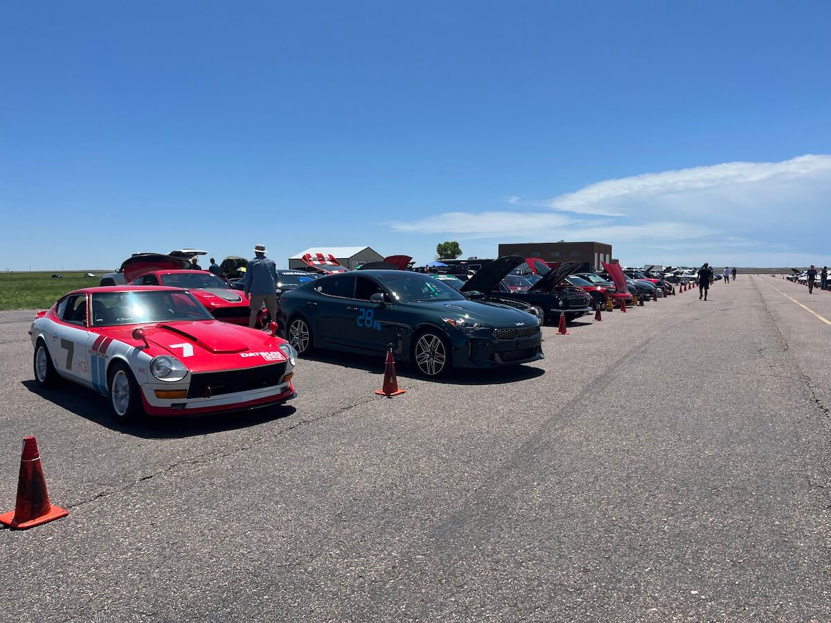 A group of cars in the pit lanes for the autocross event
