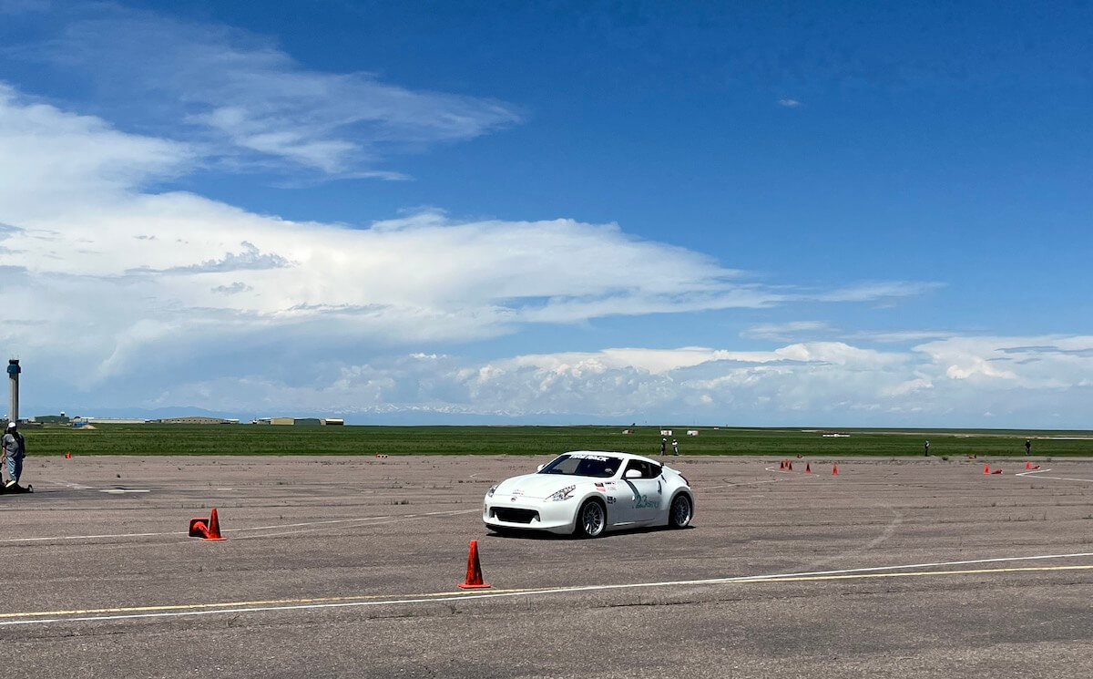 A Nissan 370Z goes around the second corner of the track.