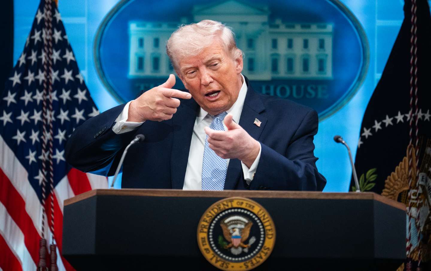 President Donald Trump mimics gunfire during an April press conference on the Iran War.