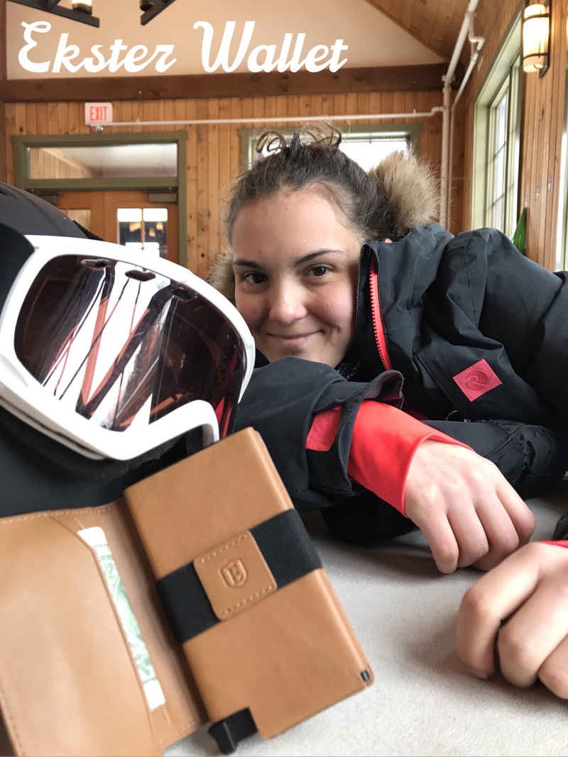 teen_in_ski_lodge_beside_ekster_wallet_and_ski_goggles