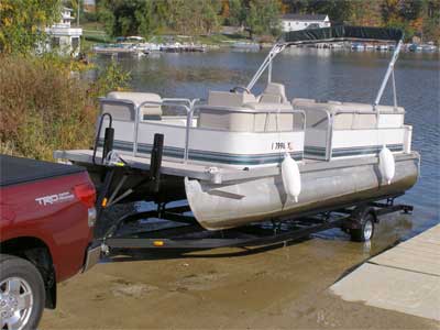 Life jackets, tow rope, towable tube and a boat. Adjusting Our Pontoon Trailer