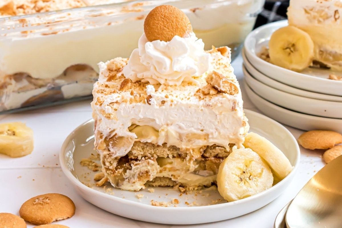 A plate of banana pudding topped with whipped cream and banana slices, perfect for Cool Whip recipes.