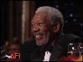 Betty White surprises Morgan Freeman at AFI awards.