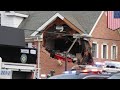 Porsche goes airborne into 2nd story of building - TomoNews